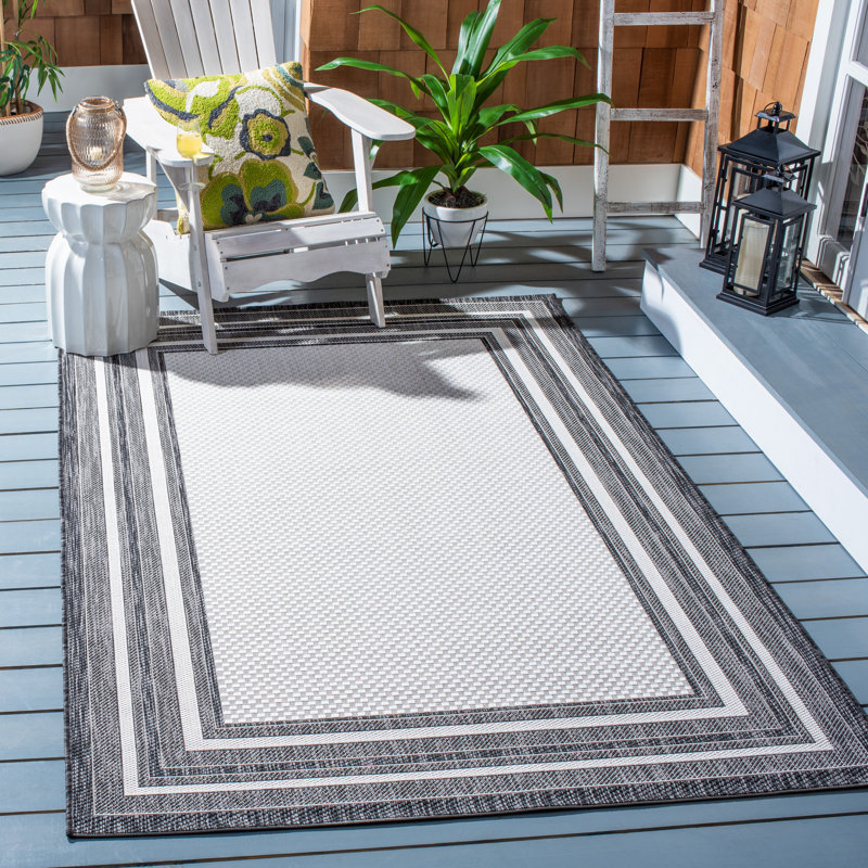 Three Posts™ Chancy Geometric Ivory/Black Indoor / Outdoor Area Rug